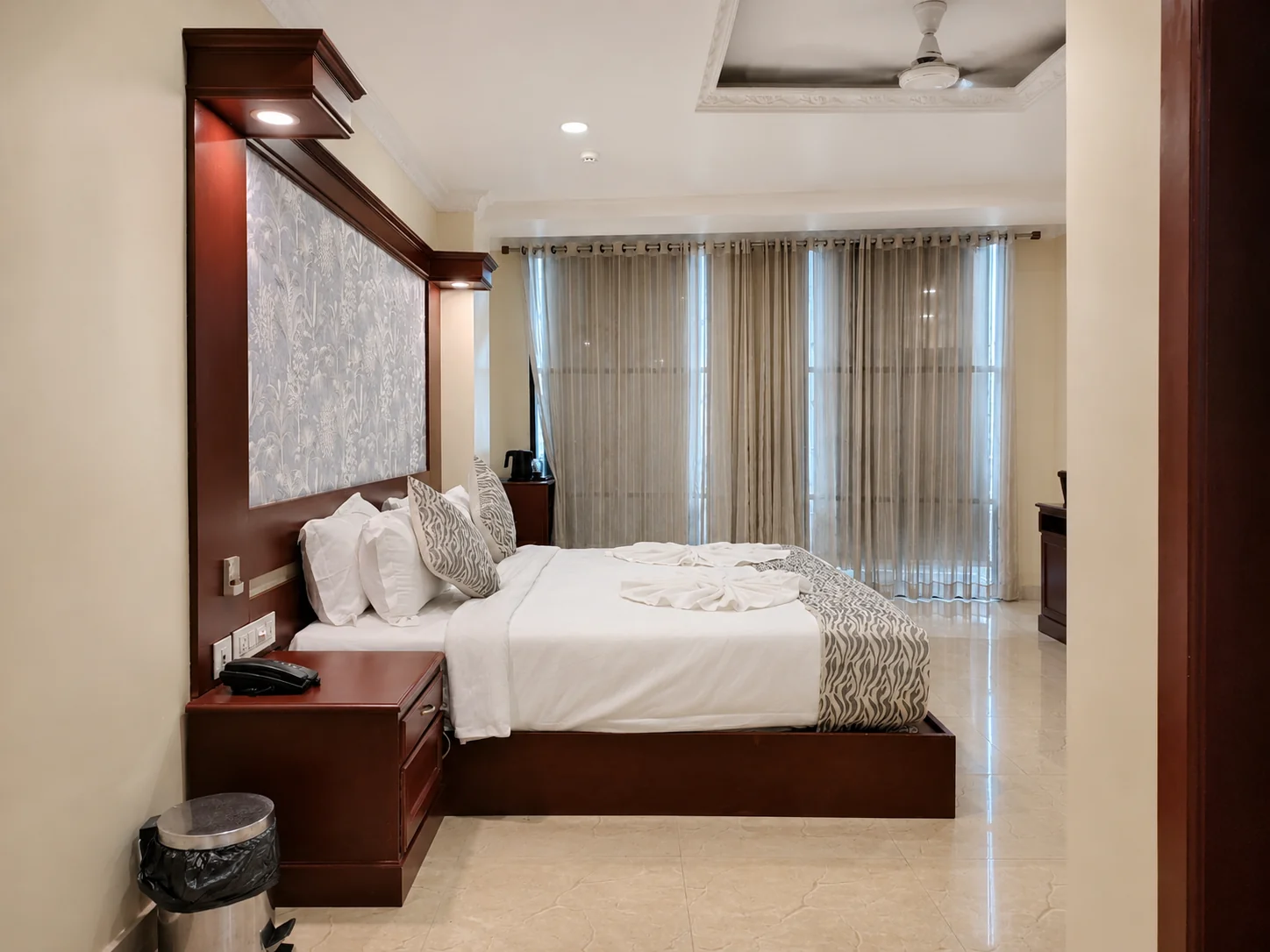 Guest room with the bed and window drapes