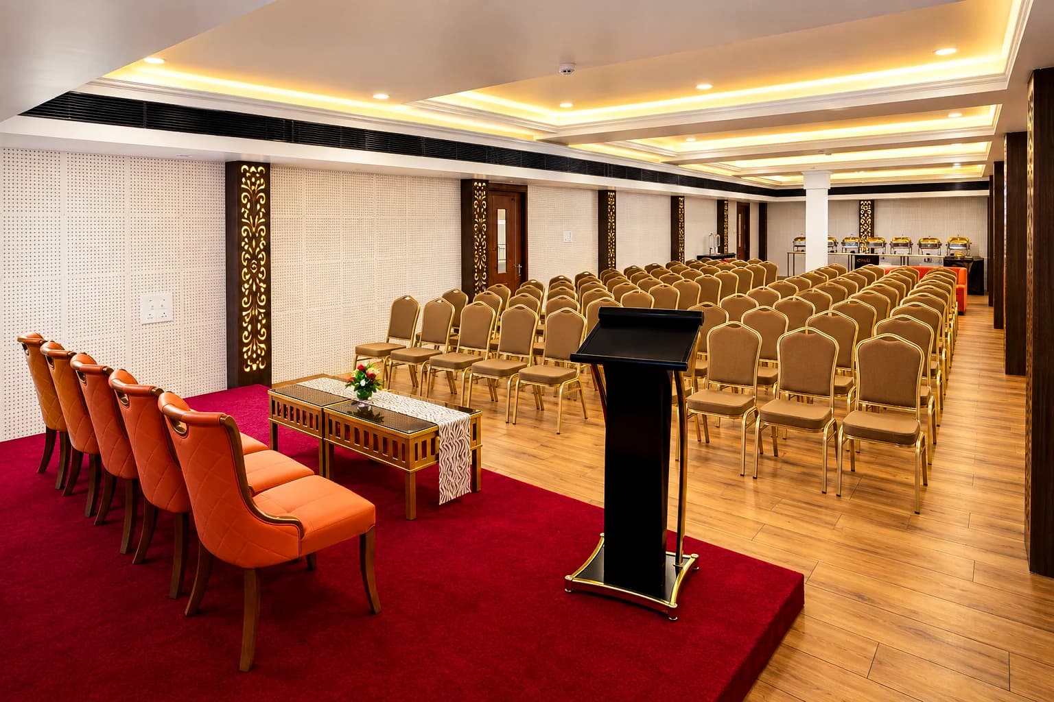 Head table on the carpeted stage at Town Hall