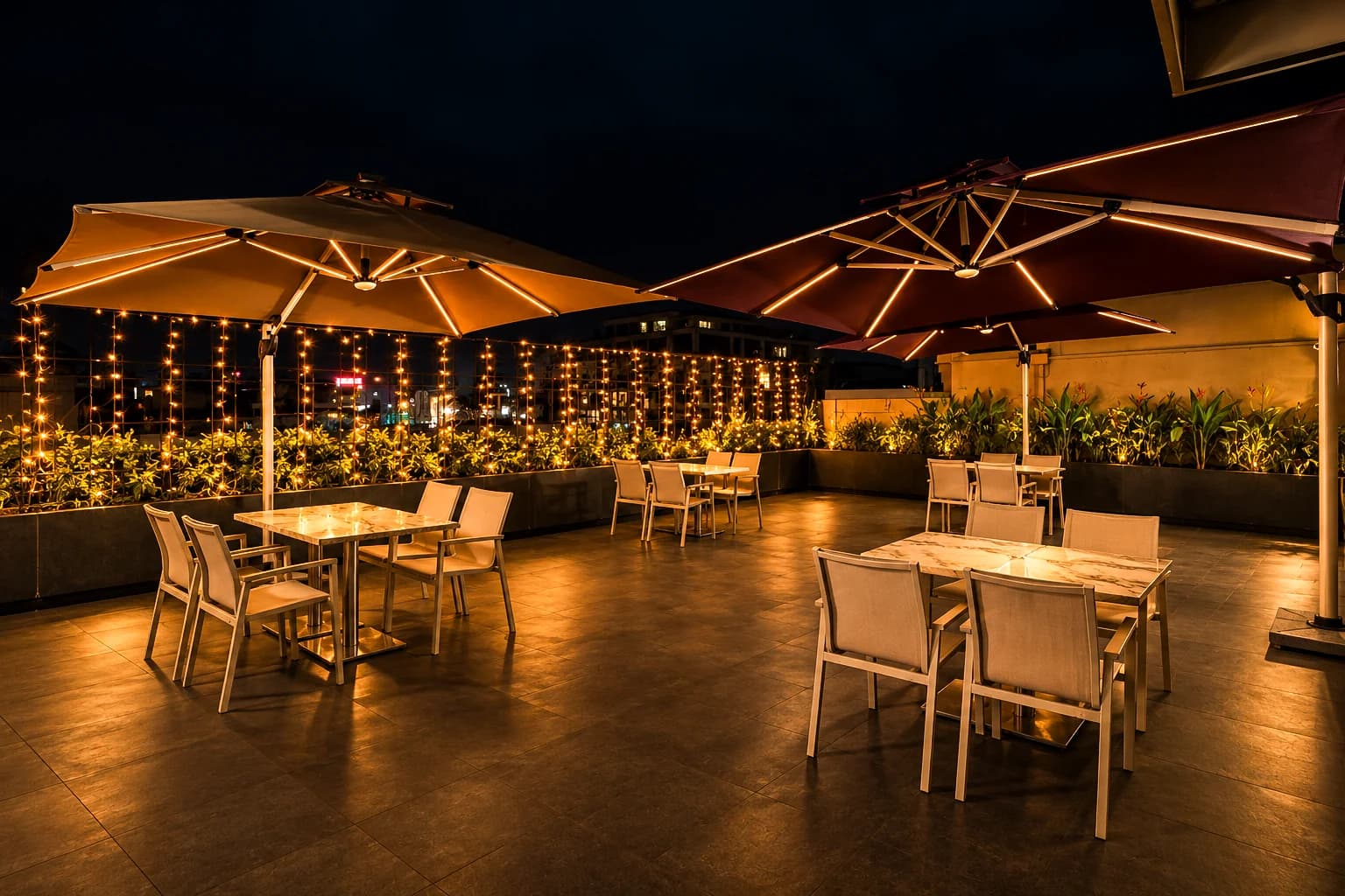 CasaBay open-air rooftop deck at night with umbrellas and string lights